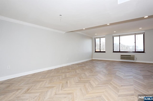 spare room with recessed lighting, baseboards, crown molding, and a wall unit AC