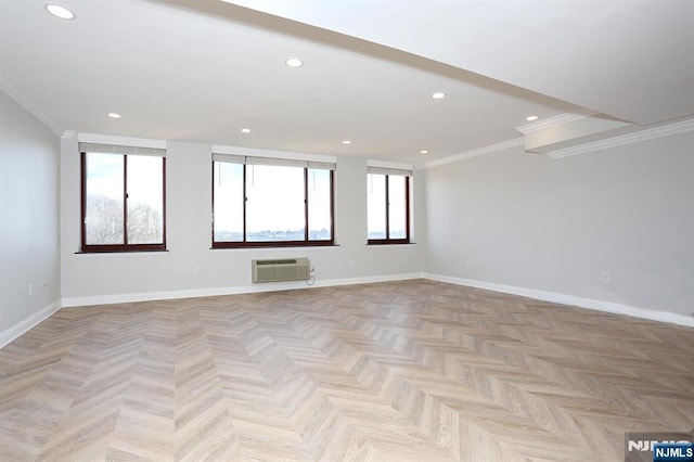 spare room featuring recessed lighting, baseboards, crown molding, and a wall mounted AC