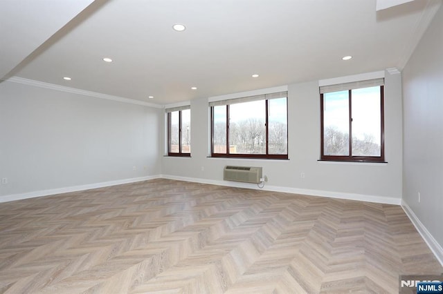 unfurnished room with recessed lighting, an AC wall unit, crown molding, and baseboards