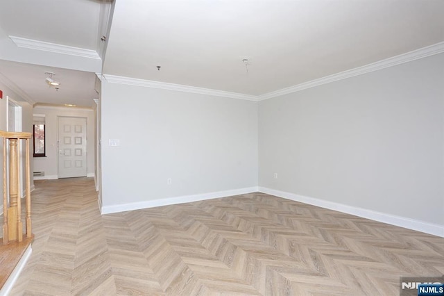 spare room with baseboards and ornamental molding