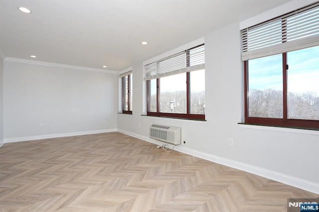 empty room with recessed lighting, a healthy amount of sunlight, a wall mounted air conditioner, and baseboards