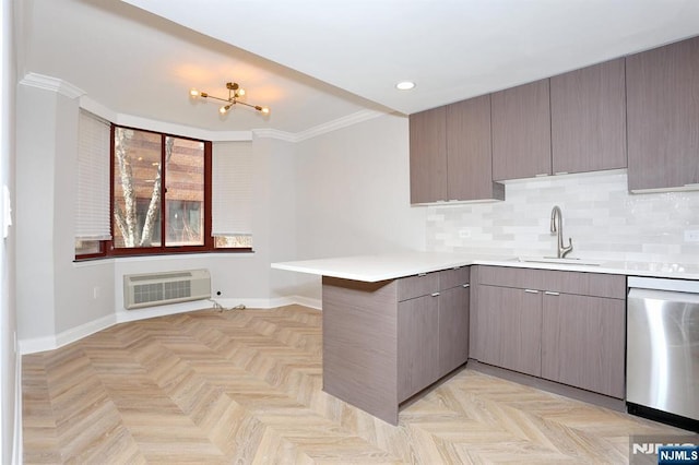 kitchen featuring an AC wall unit, a sink, tasteful backsplash, a peninsula, and dishwasher