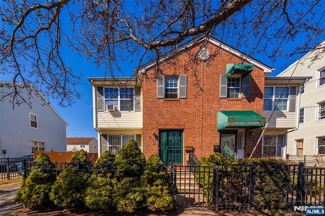 view of front of house with brick siding and a fenced front yard