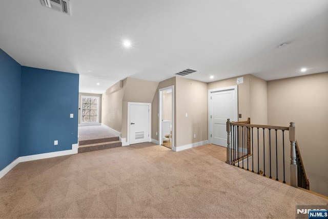 interior space featuring visible vents, carpet flooring, and baseboards