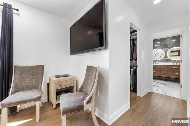 sitting room featuring recessed lighting, baseboards, and wood finished floors