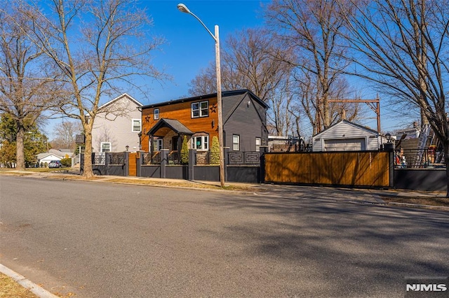 view of front facade with a fenced front yard and a gate