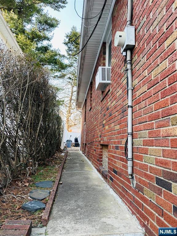 view of side of home with brick siding