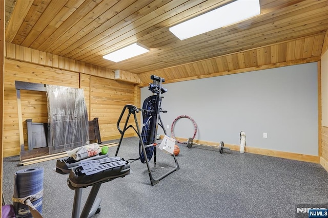 workout room featuring wooden walls, wood ceiling, lofted ceiling, and baseboards