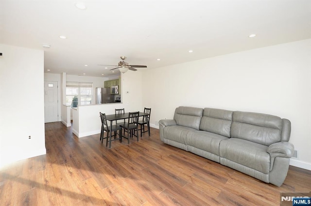 living area with recessed lighting, wood finished floors, and a ceiling fan