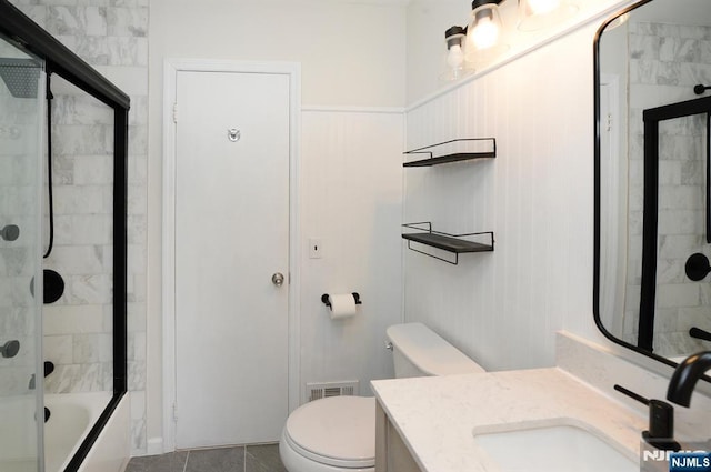 full bath with tile patterned flooring, visible vents, toilet, combined bath / shower with glass door, and vanity