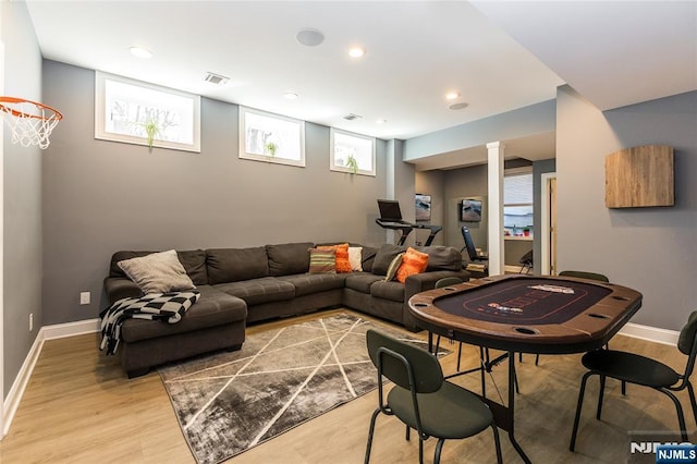 living area with recessed lighting, baseboards, visible vents, and light wood finished floors