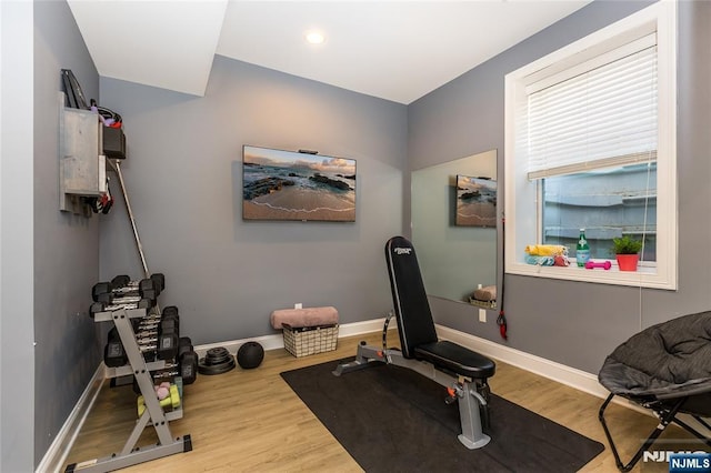 exercise area with recessed lighting, baseboards, and wood finished floors