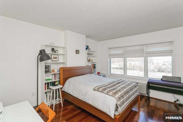 bedroom featuring multiple windows and wood finished floors