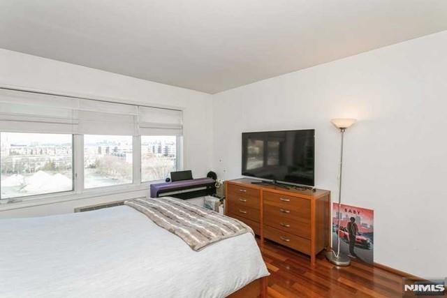 bedroom with dark wood-style floors