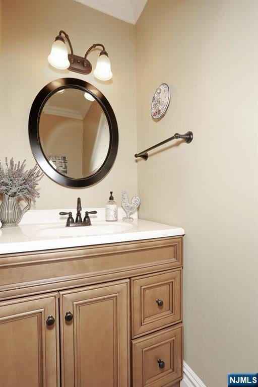 bathroom with vanity and crown molding