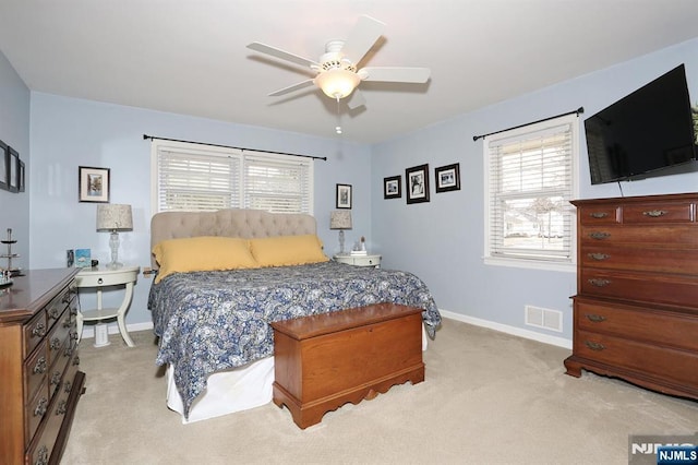 bedroom with light colored carpet, baseboards, and visible vents