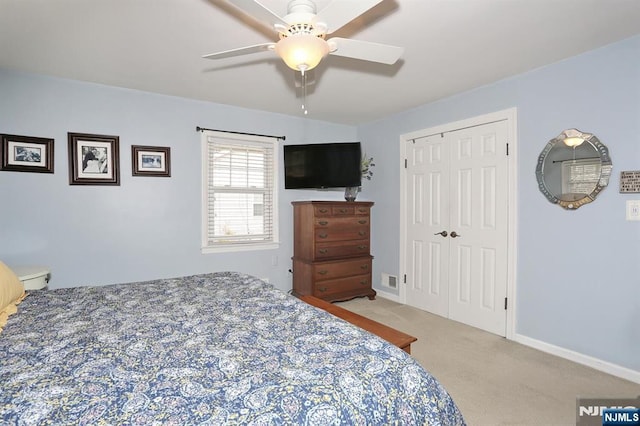 bedroom featuring a closet, carpet floors, baseboards, and a ceiling fan