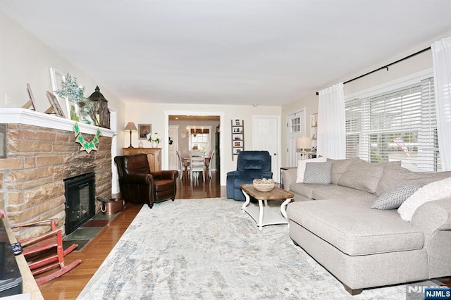 living area with plenty of natural light, a fireplace, and wood finished floors