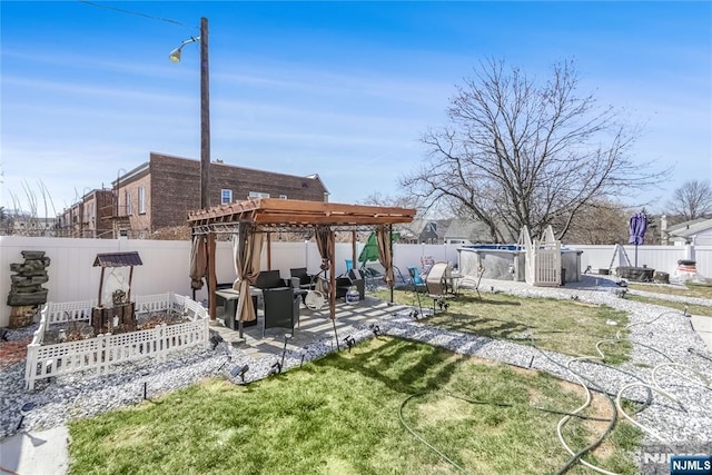 view of yard featuring a patio area, a pergola, and a fenced backyard