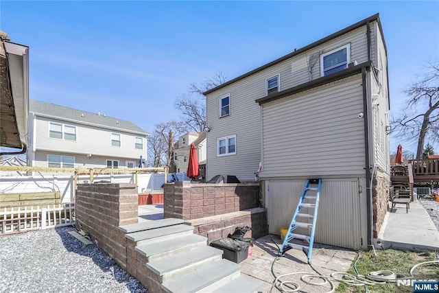 rear view of property with fence