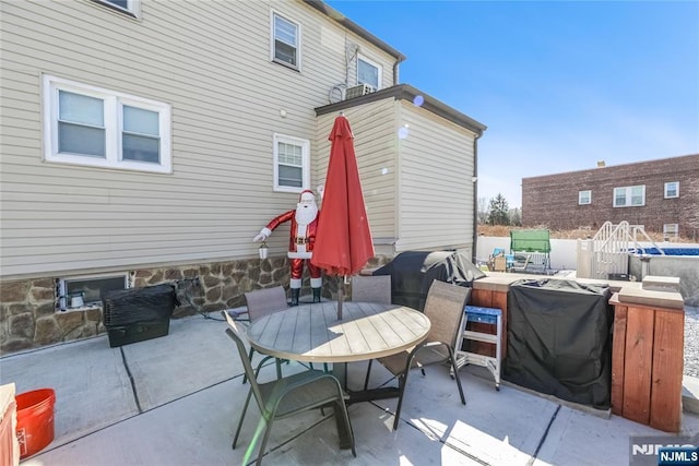 view of patio featuring area for grilling and outdoor dining area