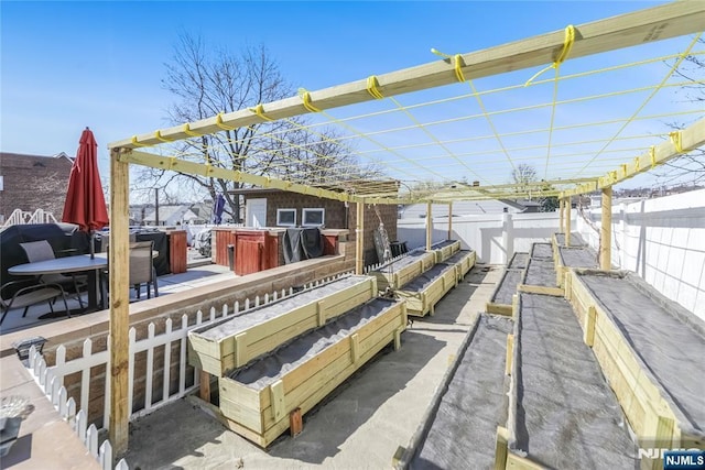 exterior space with area for grilling, a vegetable garden, and fence