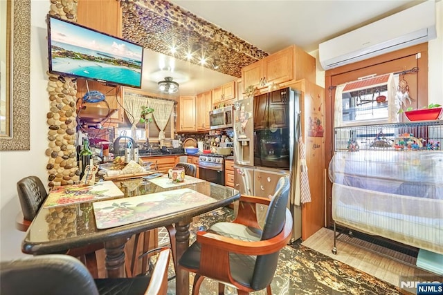 kitchen featuring a wall unit AC, dark countertops, and appliances with stainless steel finishes