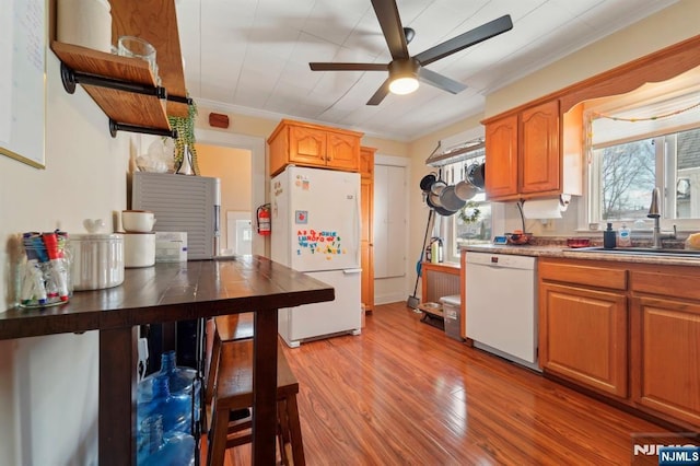 kitchen with white appliances, light wood-style flooring, a sink, ornamental molding, and ceiling fan