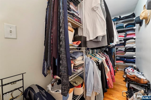 walk in closet featuring wood finished floors