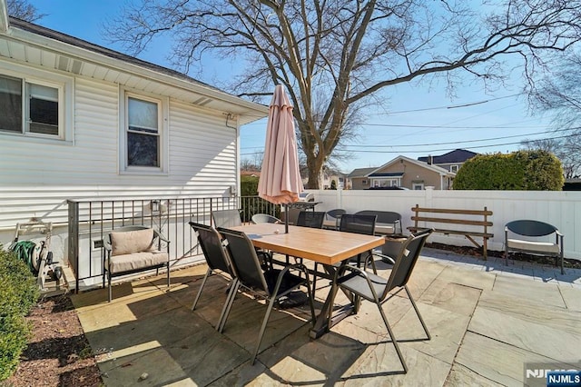 view of patio featuring outdoor dining space and fence