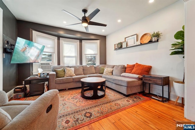 living room with cooling unit, wood finished floors, baseboards, recessed lighting, and ceiling fan