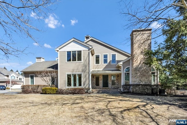 view of front of house featuring a chimney