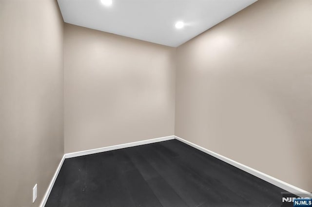 spare room with dark wood-style floors, recessed lighting, and baseboards