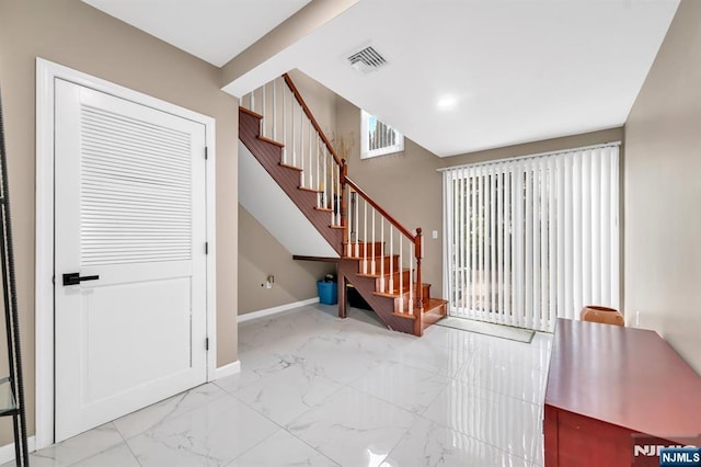 stairs with recessed lighting, visible vents, baseboards, and marble finish floor