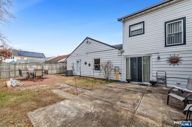 back of house featuring a patio area, central AC unit, and fence