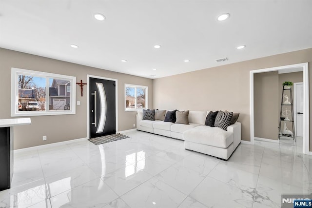 living area with recessed lighting, marble finish floor, and baseboards