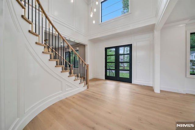 16 Donnybrook Dr, Demarest, NJ 07627 - entrance foyer featuring a decorative wall, french doors, stairs, wood finished floors, and a towering ceiling