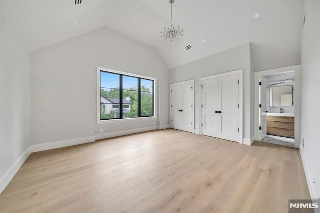 16 Donnybrook Dr, Demarest, NJ 07627 - unfurnished bedroom featuring multiple closets, light wood finished floors, a chandelier, baseboards, and vaulted ceiling