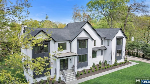 16 Donnybrook Dr, Demarest, NJ 07627 - modern farmhouse with roof with shingles, a front lawn, board and batten siding, and stucco siding