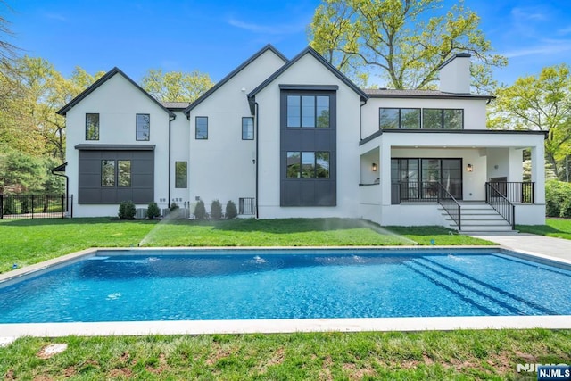 16 Donnybrook Dr, Demarest, NJ 07627 - back of property with stucco siding, an outdoor pool, and a chimney