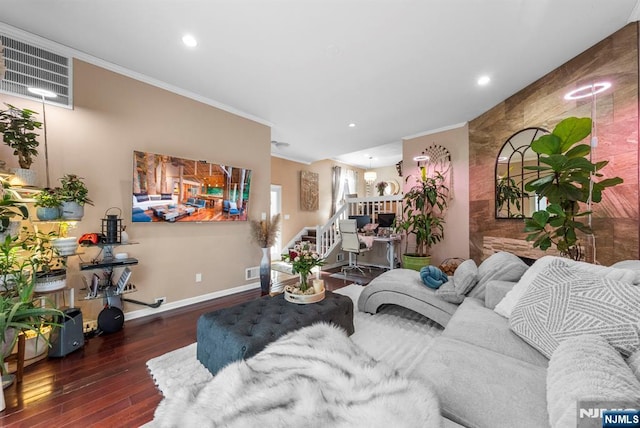 living room featuring stairway, wood finished floors, baseboards, visible vents, and ornamental molding