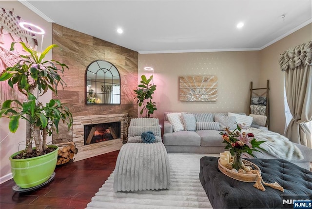 living area featuring crown molding, recessed lighting, wood finished floors, and a large fireplace