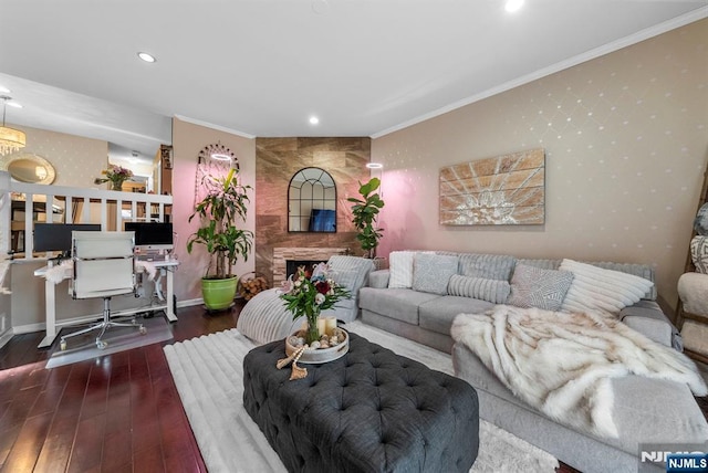 living area featuring wallpapered walls, crown molding, baseboards, a fireplace, and wood finished floors