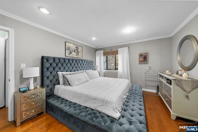 bedroom with recessed lighting, crown molding, and wood finished floors