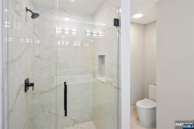 bathroom with toilet and a marble finish shower