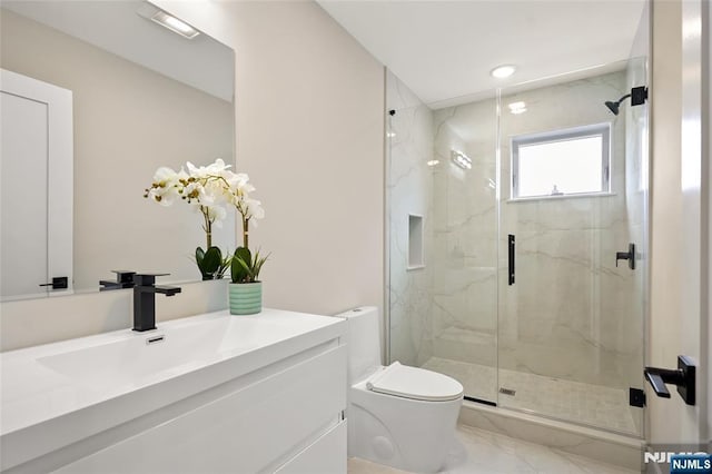 full bath featuring a marble finish shower, toilet, marble finish floor, and vanity