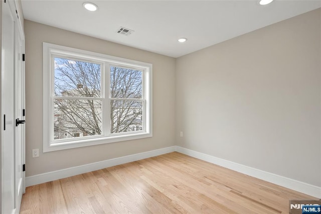 spare room with visible vents, a healthy amount of sunlight, and baseboards