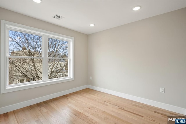 empty room with recessed lighting, visible vents, baseboards, and light wood-style floors