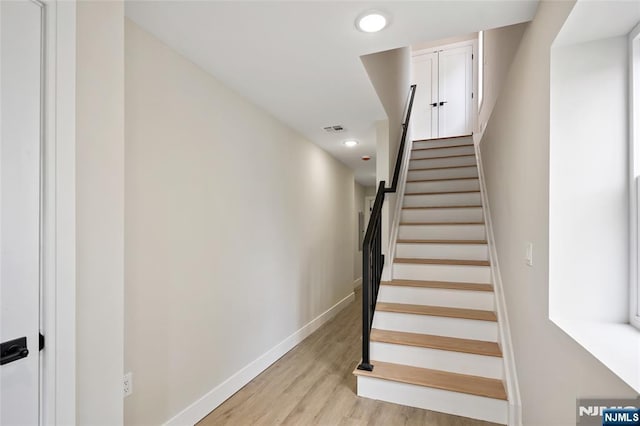 stairway with visible vents, recessed lighting, baseboards, and wood finished floors