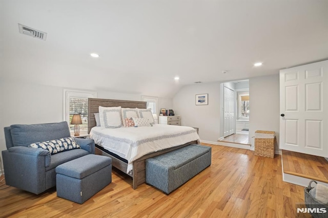 bedroom with visible vents, baseboards, lofted ceiling, recessed lighting, and light wood-style flooring